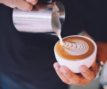 Drawing with milk on a cup of coffee